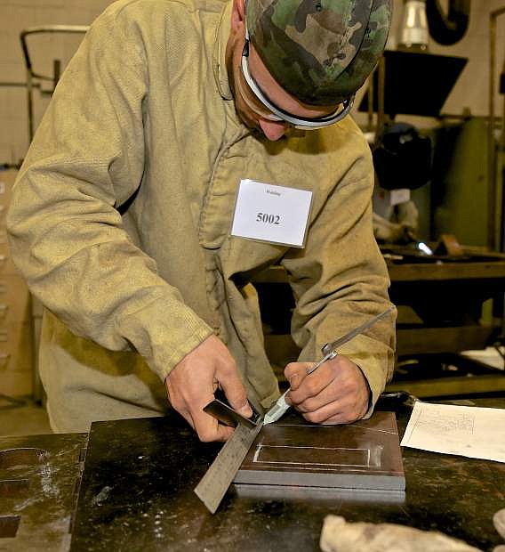 Lincoln County&#039;s Daniel Olson measures his project Thursday during the SkillsUSA competition at WNC.