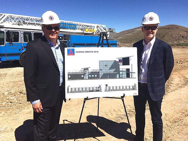 Turk Cobell, left, founder CCM Hospitality LLC., and John Mulkey, managing member of CCM, show an artists rendering of the Studio 6 Hotel &amp; Recharge Bar under construction in the Tahoe Reno Industrial Center. CCM is the franchisee for the extended-stay hotel.