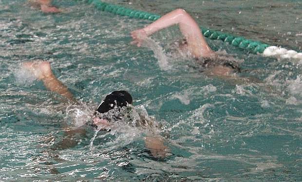 Two Greenwave swimmers pass as they do practice swims at the Churchill County pool.