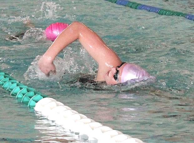 Haley Nelson passes a teammate during her training laps in the Churchill County Pool.