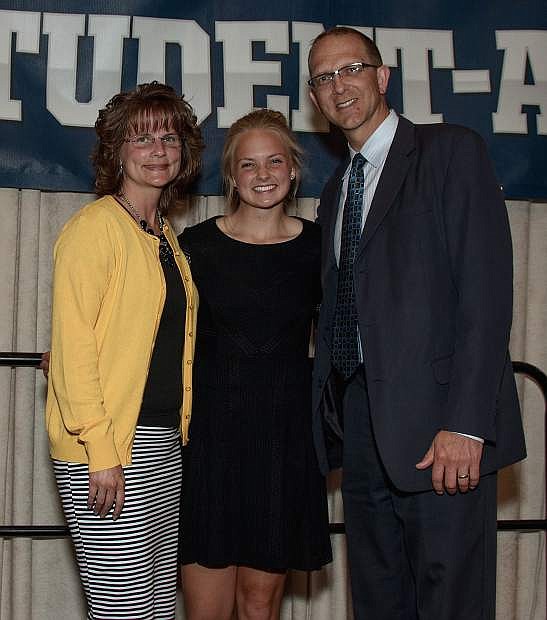Hoyt and Carmen Skabelund surround their daughter, Whitney, after she received the NIAA&#039;s Top 10 Student-Athlete honor Wednesday night at the Peppermill in Reno.