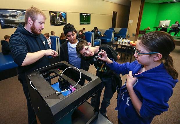Librarian Aubrey White talks to teens, from left, Anu Praveen, Seth Taylor and Jessica Artz about using the 3D printer during a program at the Carson City Library in January 2016. Nevada library representatives will be meeting with lawmakers on April 12 to discuss statewide library programs. Photo by Cathleen Allison/Nevada Photo Source