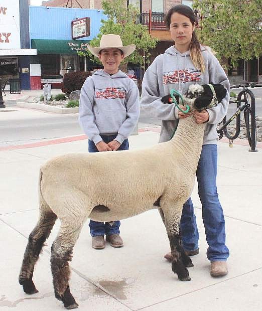 Lonnie Adams and Angel Arteaga show a lamb to promote this week;s Churchill County Junior Livestock Show and Sale Thursday-Saturday at the fairgrounds. FFA and 4-H members participate in the annual event.