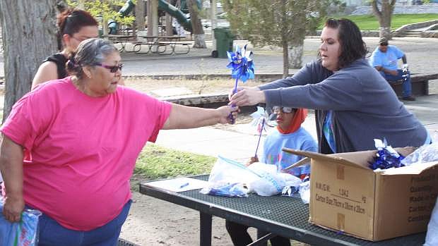 Miranda Chappell, right, hands out a pinwheel during registration.