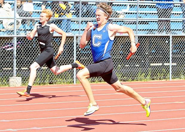 Carson&#039;s Harry Meyer battles with Douglas&#039; Sean Wolfkiel in the 4A boys 4x200-meter relay Saturday at the Jim Frank Track and Field Complex.