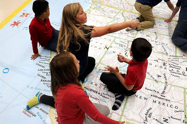 Students at Bordewich Bray Elementary discuss which lands belong to the United States, based off of National Geographic&#039;s map.