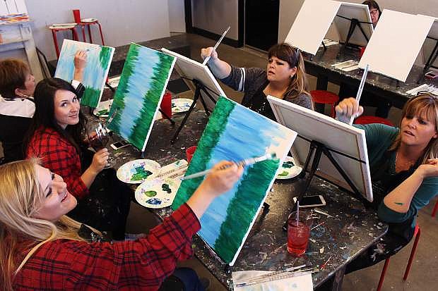 Three generations enjoy the camaraderie of painting together. From far left: Grandmother/mother Kathy McDuffie of Minden; granddaughters Maddy McDuffie of Gardnerville and Megan Dube of Minden; daughters Shauna Willette and Casey Dube of Minden.