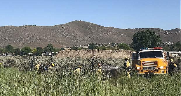 Carson City Fire Department responded to reports of a fire burning in a field off of Country Village Drive, behind the Tanglewood Apartments around 3:40 p.m. Monday.