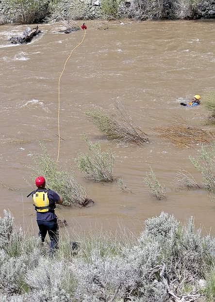 Capt. Jason Danen hurls a throw bag to a &#039;victim&#039; floating down the Carson River Wednesday during training.