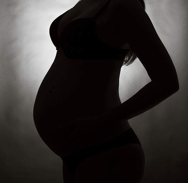 Pregnant woman silhouette with gray background