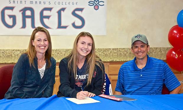 Carson High soccer standout Valerie Sue Meyer, pictured here with her parents Jerry and Nicole, signs her letter of intent to play at St. Mary&#039;s College in Moraga, Calif. Wednesday at CHS.