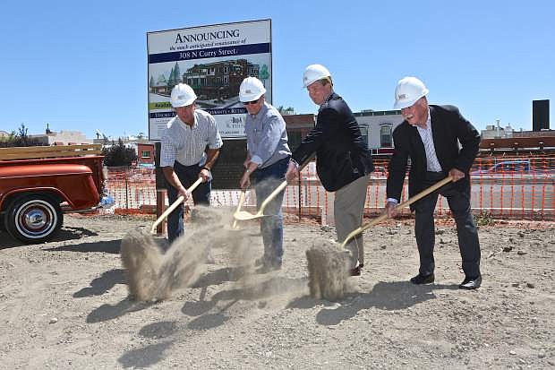Hop and Mae Adams Foundation trustees Chris MacKenzie, Steve Neighbors and Ed Ahrens along with Mayor Bob Crowell (3rd from left) scoop dirt at 308 N. Curry St. for the groundbreaking of the new multi-use complex in July 2016.