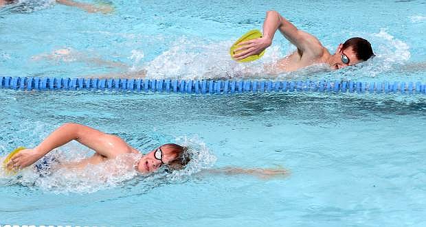 Tigersharks swim team members Tyler Crisp and Robbie Daugherty train at the Carson Aquatic Center on Tuesday afternoon. The Tigersharks will team up with the city to host a kids marathon on July 15 at Mills Park.