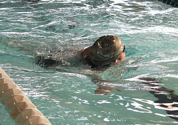 Courtney Romero takes a breath of air during a lap of Churchill County Community Pool during a swin team practice.