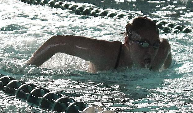 Amber Revels practices her butterfly stroke during a swim team practice session.