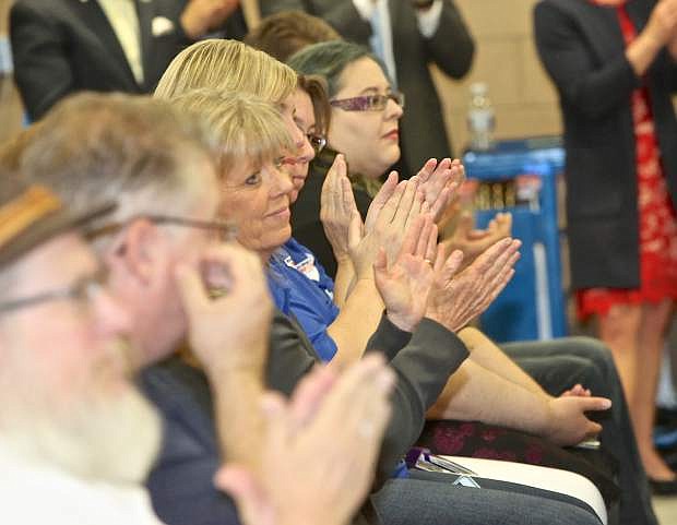 Signing ceremony attendees applaud as Gov. Sandoval signs a pair of education bills Wednesday at WNC.