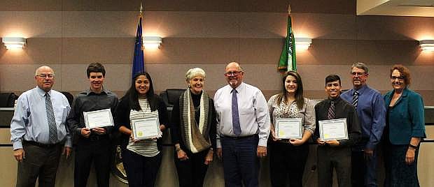 County youth are presented with 2017 Jim Regan Memorial Scholarships; from left, Commissioner Bus Scharmann, Michael Richards II, Isabel de la Cruz Martinez, Evie Regan, Commissioner Pete Olsen, Kathrine Vick, Ethan Smith, Commissioner Carl Erquiaga and Employee Management Committee Chair Pamela Moore.