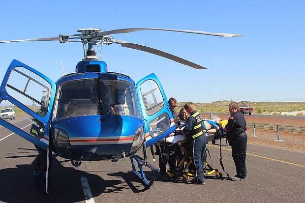 Paramidics begin to load an injured man into the Care Flight helicopter.