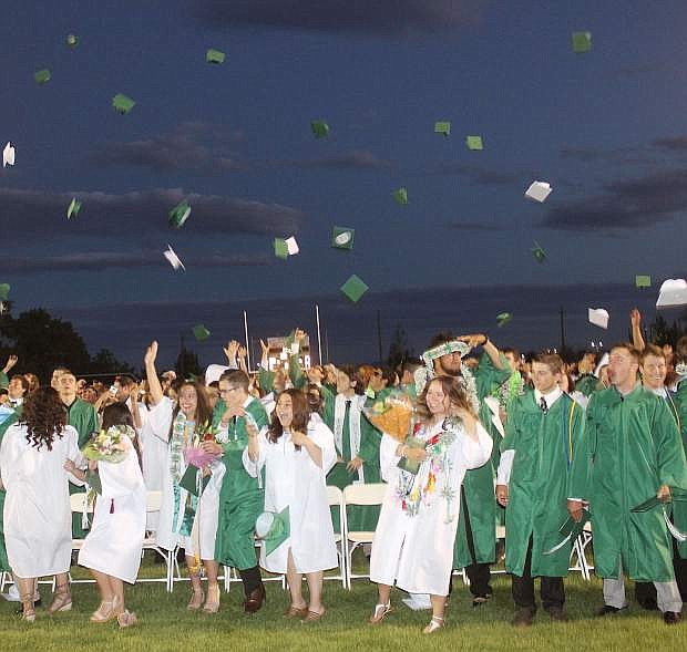 The Churchill County High School class of 2017 toss their graduation caps to the wind Friday night on the Edward Arciniega Athletic Complex&#039;s football field.