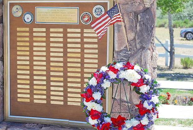 A wreath is placed every Memorial Day by the names of military service members at the Fallon Paiute-Shoshone Tribal Cemetery .
