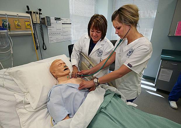 Instructor Lisa Dunkelberg watches nursing student Lisa Pourde during exercises in the nursing lab at Western Nevada College in Carson City, Nev., on Monday, April 6, 2015. Photo by Cathleen Allison