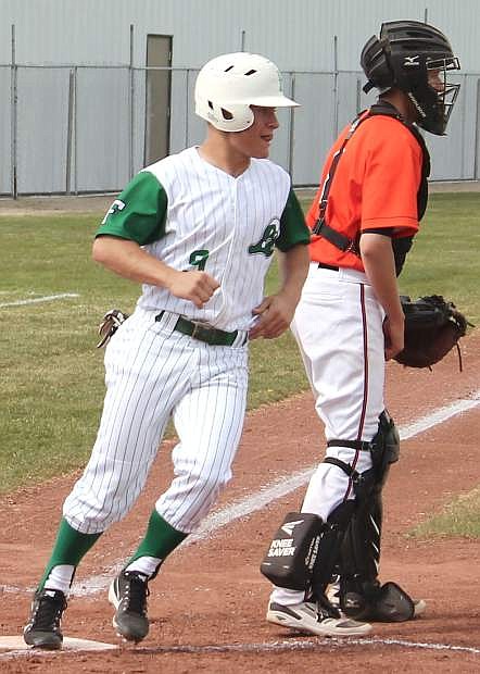 Jack Swisher crosses home plate after working his way around the bases in a Greenwave game against Fernley.