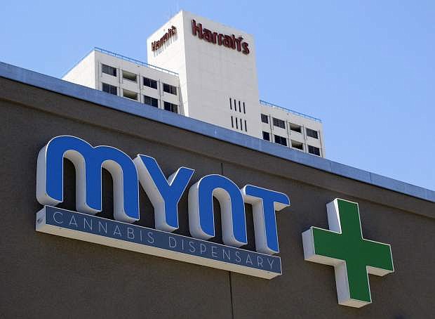 A sign on the Mynt Cannabis Dispensary across the street from Harrah&#039;s hotel-casino in downtown Reno, Nev., is pictured Wednesday, June 21, 2017. The Mynt is one of at least four medical marijuana dispensaries in Reno that have received the necessary local licenses and are ready to start selling marijuana for recreational use on July 1 if the state is able to comply with a court order regarding distribution licenses. (AP Photo/Scott Sonner)