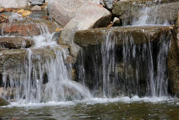 Water cascades over a 4-foot waterfall and into a pond at the home of Tim and Christina Stevens.