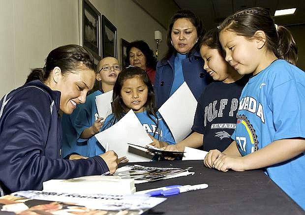 Tahnee Robinson signs an autograph for Native children at a previous Nevada Wolfpack Basketball Camp in Carson City