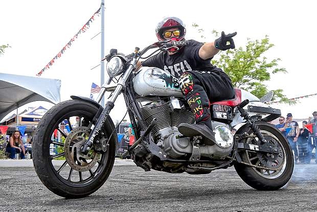 Milt Maos (aka WhiteBoyMobbin&#039;) of San Francisco performs with his West Coast Connection stunt crew Saturday during a spring Street Vibrations performance at Battle Born Harley Davidson in Carson.