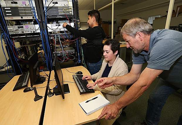 CISCO Technology Instructor Dave Riske works with students Sergio Teutli, rear, and Chrissa Johnson at Western Nevada College in Carson City, Nev., on Wednesday, April 27, 2016. Photo by Cathleen Allison