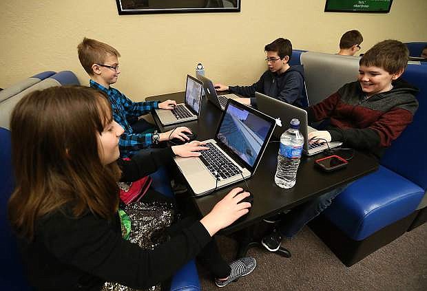 From left, Josie Verive-Cain, Kyle Brune, Nicolas Baggio and Lucas Stocz participate in a Minecraft workshop at the Carson City Library in 2016. Nevada Gov. Brian Sandoval signed a bill Thursday providing an additional $500,000 for statewide library programs. Photo by Cathleen Allison/Nevada Photo Source