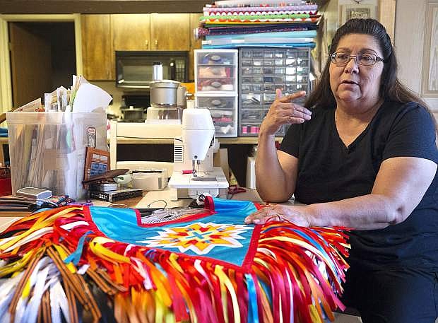 Great Basin Native Artist Joyce McCauley talks about the regalia she creates for Native American dancers. McCauley is one of several artists whose work will appear in the second installment of the Great Basin Native Artists show. Photo by Cathleen Allison/Nevada Photo Source
