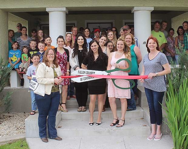Darity Openshaw, left, and her sister Blair Johnson, cut the ribbon to announce the reopening of their business in a larger building. Holding the ribbon are Amber Ayers, left, and Valerie Johnson, both from the Chamber of Commerce.