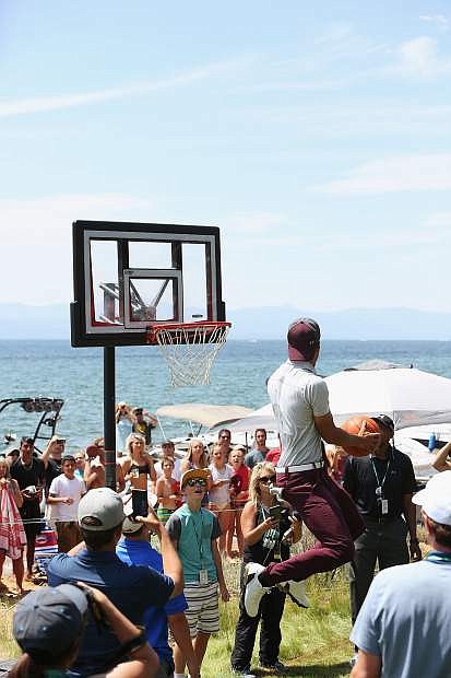 Steph Curry attempts to dunk on the portable hoop on the 17th tee Friday.