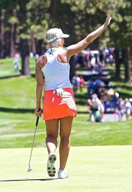Pro golfer Blair O&#039;Neal acknowledges the crowd after a beautiful putt on the 16th green Saturday.