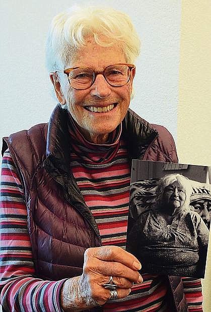 Minden photographer Nancy Raven holds a small copy of one of the photos on display at the Douglas County Historical Society.