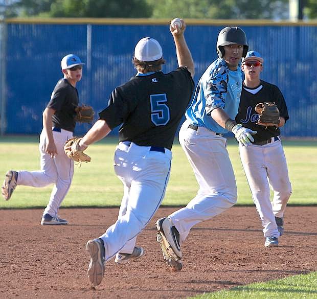Abel Carter and his Blue Jays teammates run down an NBO player during tournament play Saturday at Carson High.