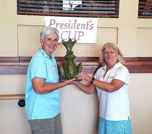 Mary Kay Kaluza, president, receives a special trophy from Annette Ramiriz, tournament chair, during the Eagle Valley Women&#039;s Golf Club&#039;s President&#039;s Day Tournament.