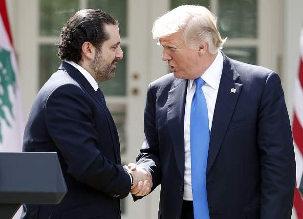 President Donald Trump shakes hands with Lebanese Prime Minister Saad Hariri during a joint news conference in the Rose Garden of the White House in Washington, Tuesday, July 25, 2017. (AP Photo/Alex Brandon)