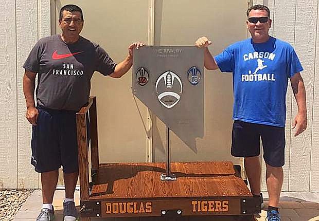 Douglas coach Ernie Monfiletto, left, and Carson coach Blair Roman show off the new &quot;Rivalry Trophy&quot; that will be up for grabs when the Tigers and Senators play in November.