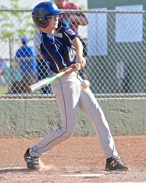 Aiden McNabb punches a single for the 12-year-old Carson All-Star&#039;s Thursday night against Centennial.