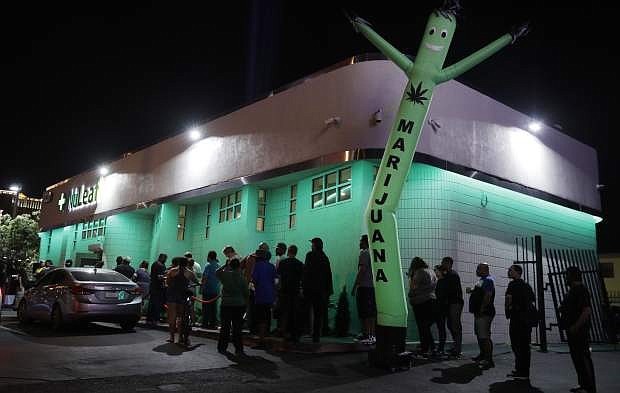 People line up at the NuLeaf marijuana dispensary, Saturday, July 1, 2017, in Las Vegas. Nevada dispensaries were legally allowed to sell recreational marijuana starting at 12:01 a.m. Saturday. (AP Photo/John Locher)