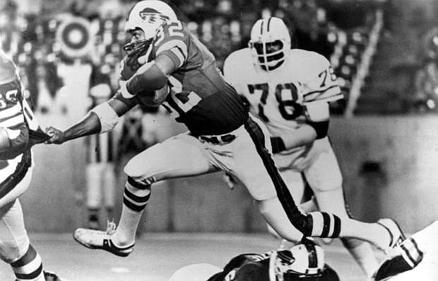 FILE - In this Sept. 3, 1977 file photo, Buffalo Bills&#039; O.J. Simpson (32) runs past Tampa Bay Buccaneers&#039; Council Rudolph (78) during an NFL football game in Buffalo, N.Y. Simpson, the former football star, TV pitchman and now Nevada prison inmate, will have a lot going for him when he appears before state parole board members Thursday, July 20, 2017, seeking his release after more than eight years for an ill-fated bid to retrieve sports memorabilia. (AP Photo, file)