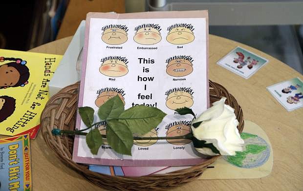 A single white rose rests on the &quot;peace table&quot; at the Verner Center in Asheville, N.C., on Thursday, March 23, 2017. The spot is designated to help angry kids work out conflicts with their classmates. (AP Photo/Chuck Burton)