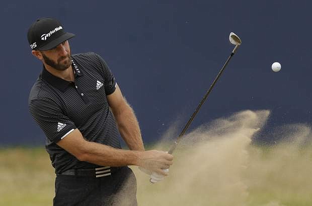 Dustin Johnson of the United States plays out of the bunker on the 18th hole during a practice round Wednesday ahead of the British Open at Royal Birkdale, Southport, England.