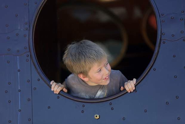 Tucker Thompson, 8, looks out the window of the McKeen Motor Car while taking a train ride at the Nevada State Railroad Museum on Monday afternoon.