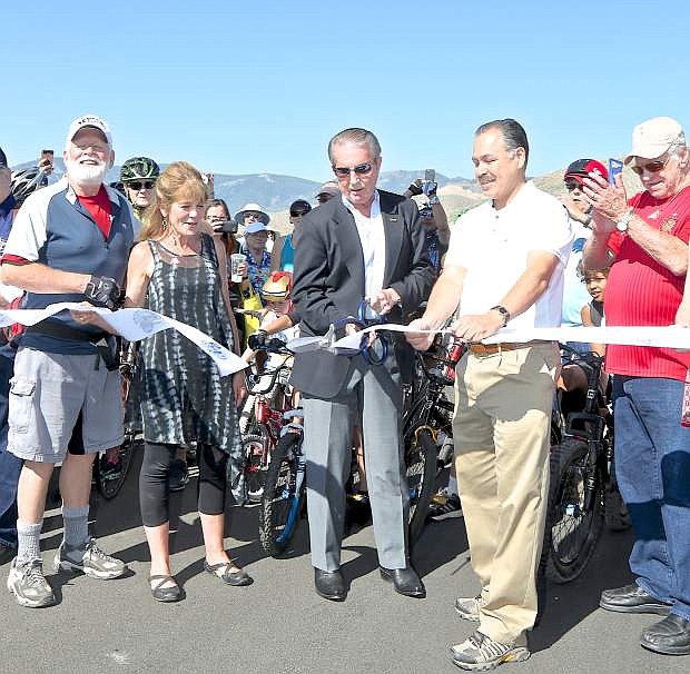 Carson City Mayor Bob Crowell cuts the ribbon on the new section of I-580 with the help of Supervisors John Barrette, Karen Abowd and NDOT Director Rudy Malfabon Saturday morning.
