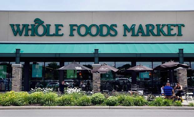 FILE - This Friday, June 16, 2017, file photo shows a Whole Foods Market in Indianapolis. Amazon is moving swiftly to make big changes at Whole Foods, saying it plans to cut prices on bananas, eggs, salmon, beef and more as soon as it completes its $13.7 billion takeover. (AP Photo/Michael Conroy, File)