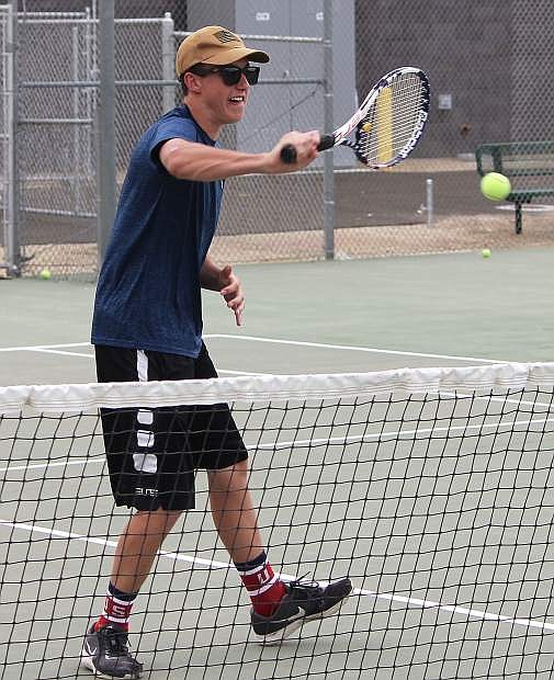 Blake Malcovich practices his returns at the Churchill County High School tennis court.